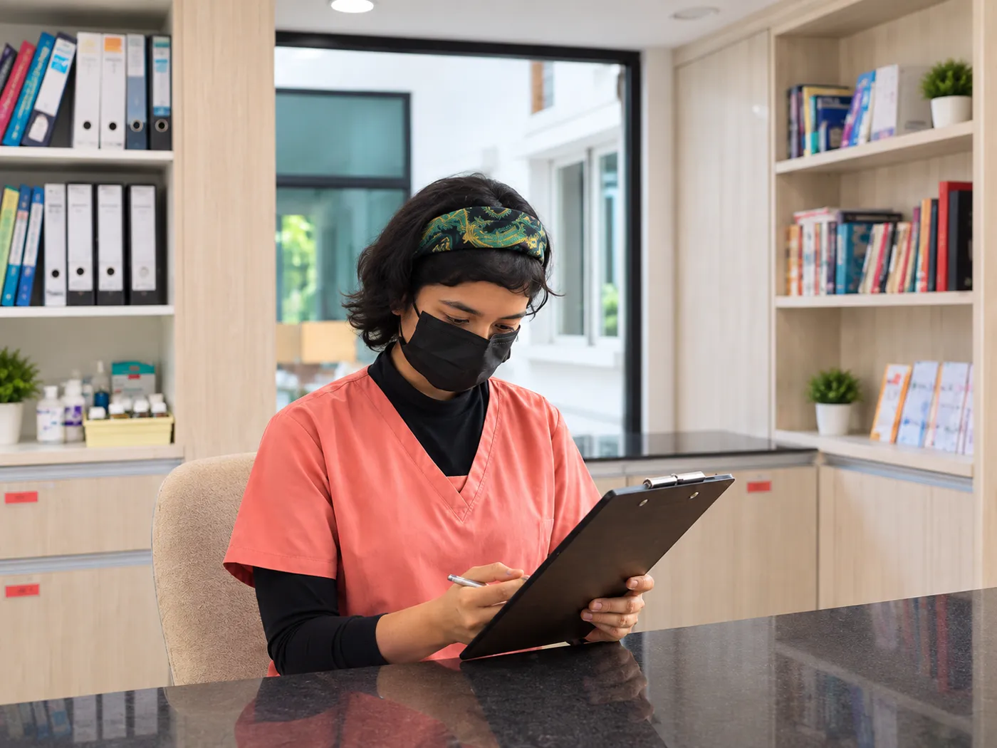 A nurse reviewing a resident's care plan at a Mercy Senior Care Centre
